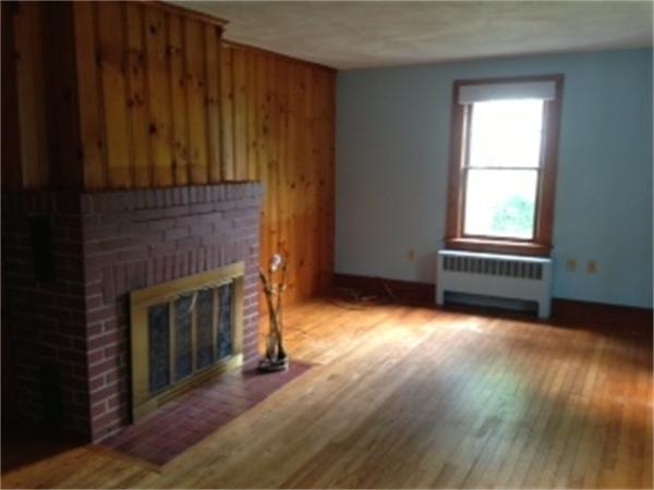 399 Burts Pit Road Northampton, MA 01062 - Photo 3 of 6 a view of empty room with wooden floor and fireplace