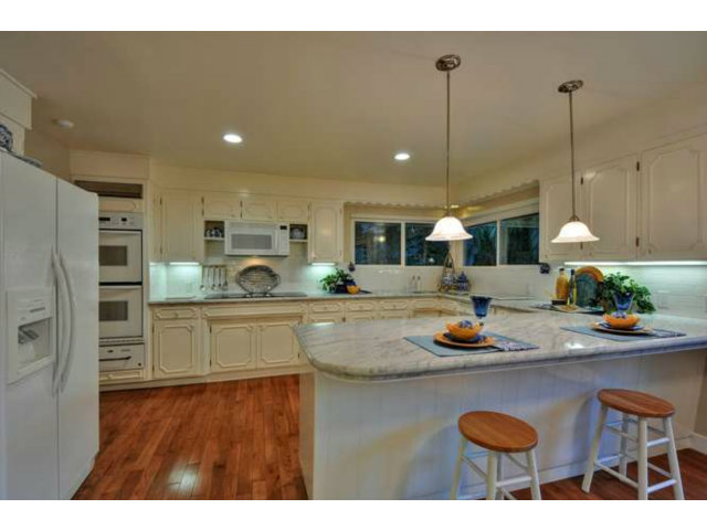 15722 Lancaster Road Monte Sereno, CA 95030 - Photo 5 of 23 a kitchen with sink a stove and chairs