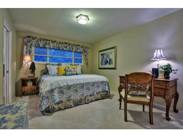 15722 Lancaster Road Monte Sereno, CA 95030 - Photo 10 of 23 a bedroom with a bed and a chair