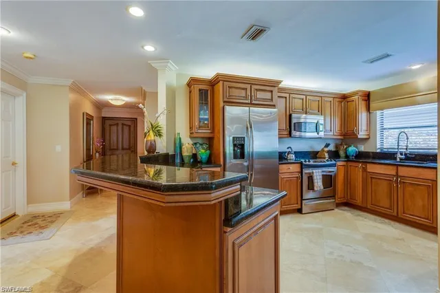 a kitchen with stainless steel appliances granite countertop a sink and cabinets