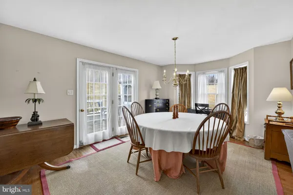 a kitchen with stainless steel appliances white cabinets and wooden floor