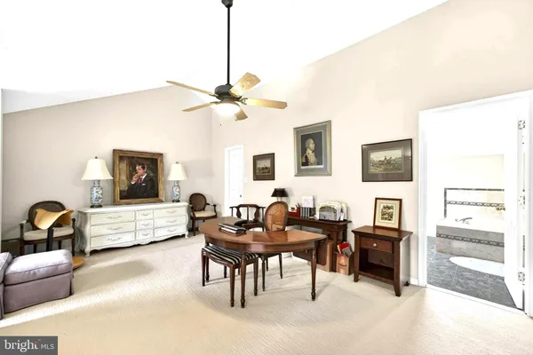 a spacious bedroom with a bed and a chandelier