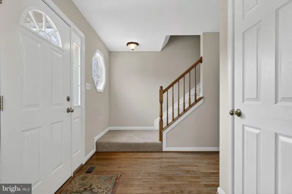 a view of a hallway with wooden floor and windows