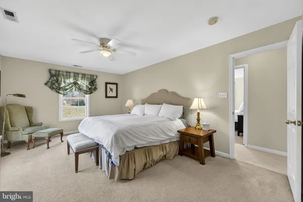 a view of a room with a hanging light and kitchen