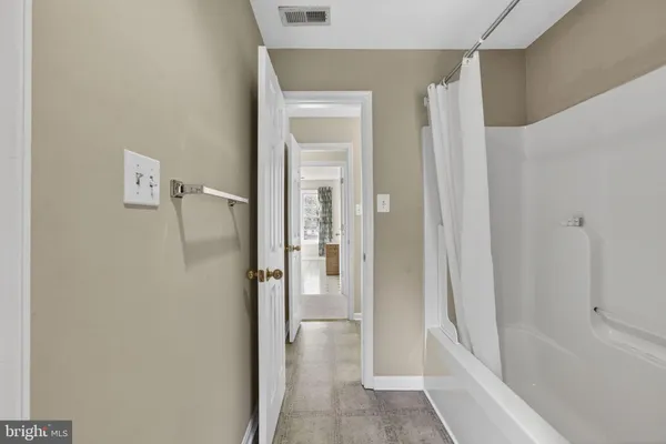 a bathroom with a bathtub and shower