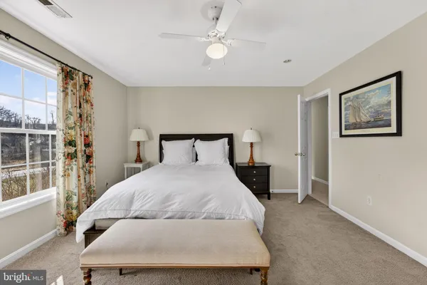 a swimming pool that has lawn chairs under an umbrella