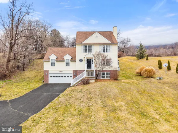 a living room with furniture a fireplace and a large mirror