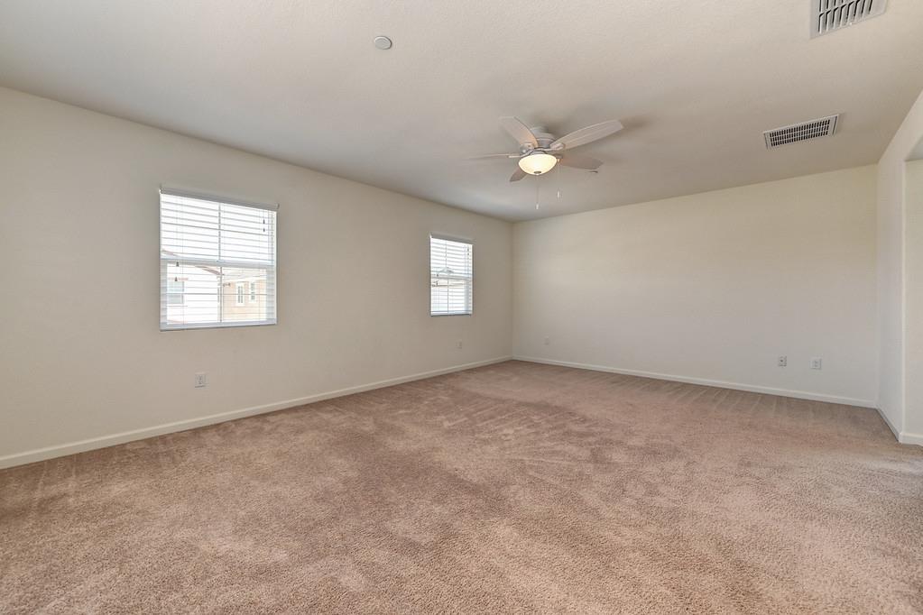 3231 Foxton Way Rancho Cordova, CA 95670 - Photo 21 of 29 an empty room with windows and ceiling fan