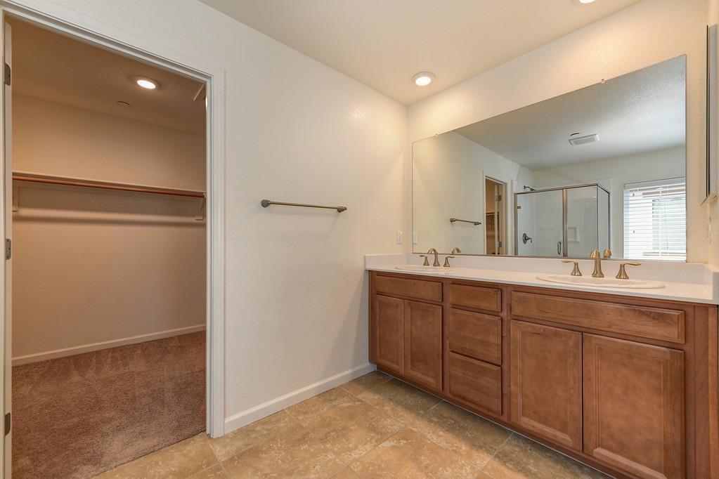 3231 Foxton Way Rancho Cordova, CA 95670 - Photo 23 of 29 a spacious bathroom with a double vanity sink and a mirror