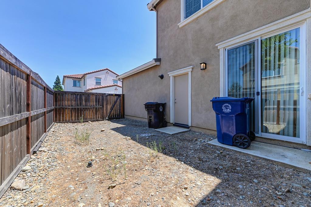 3231 Foxton Way Rancho Cordova, CA 95670 - Photo 26 of 29 a view of a backyard with wooden fence and a floor to ceiling window