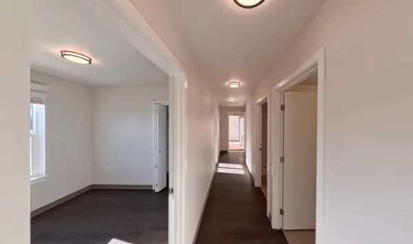a view of a hallway with wooden floor