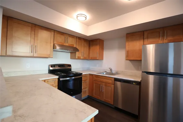 a kitchen with a sink a stove and refrigerator