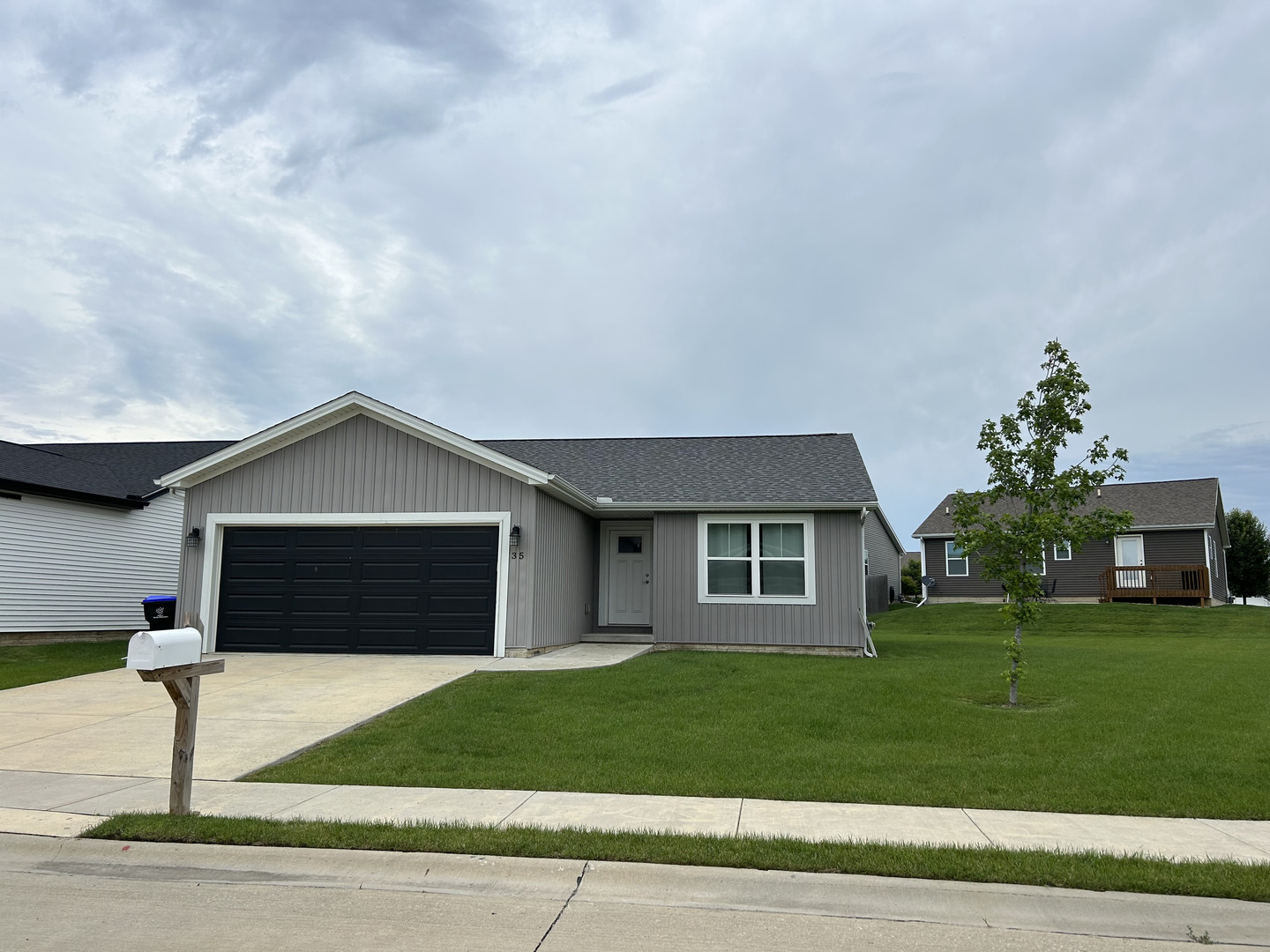 35 Winding Way Bloomington, IL 61705 - Photo 1 of 5 a front view of a house with a yard and garage