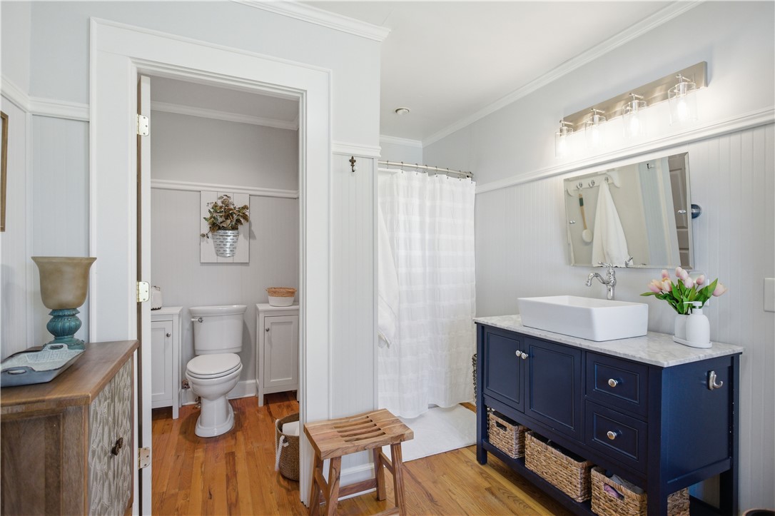 310 Retreat Street Westminster, SC 29693 - Photo 12 of 46 This bright bathroom features natural wood flooring and classic wainscoting.