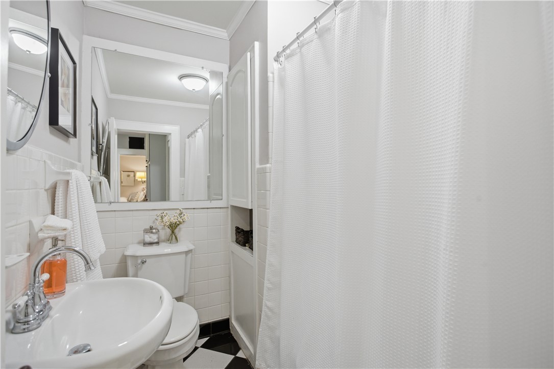 310 Retreat Street Westminster, SC 29693 - Photo 16 of 46 This bathroom features classic checkerboard flooring and white subway tile, creating a timeless aesthetic.