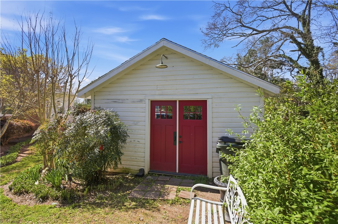 310 Retreat Street Westminster, SC 29693 - Photo 28 of 46 This charming detached garage with bold red doors offers functional utility and delightful aesthetic appeal.