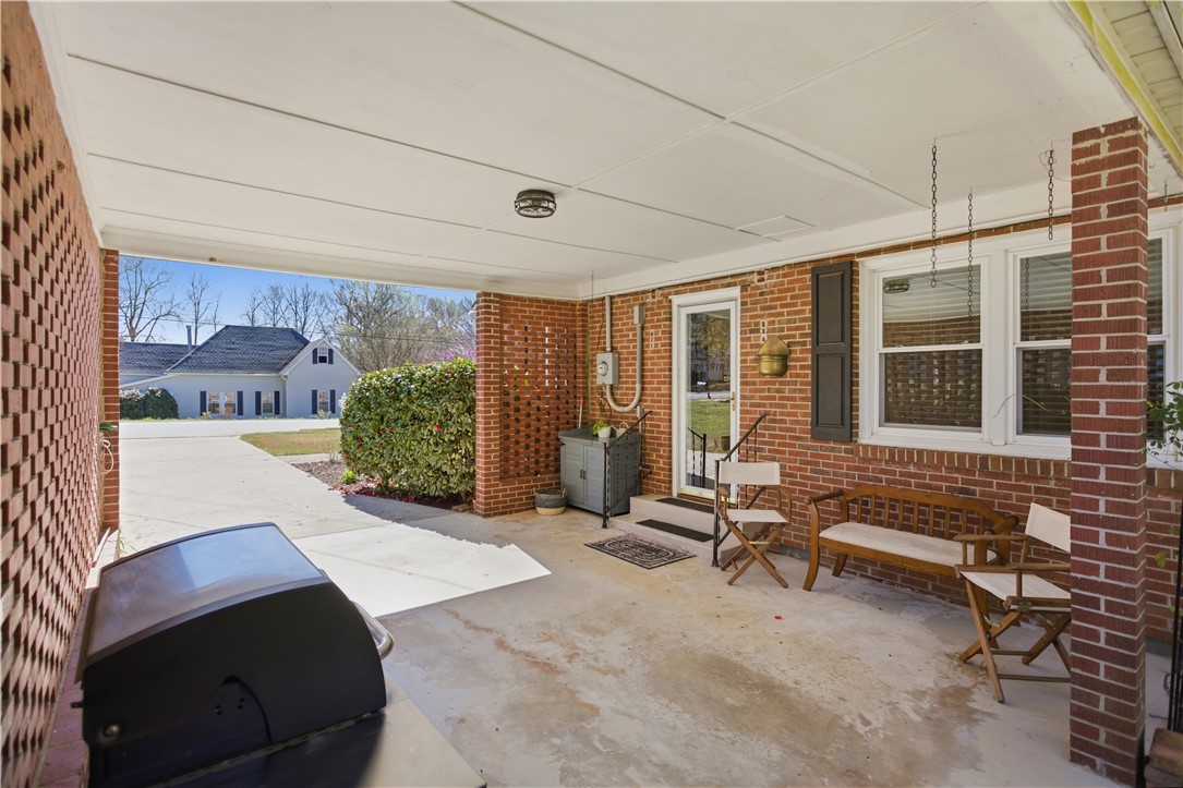 310 Retreat Street Westminster, SC 29693 - Photo 34 of 46 This inviting exterior features a covered patio perfect for outdoor living and entertaining.