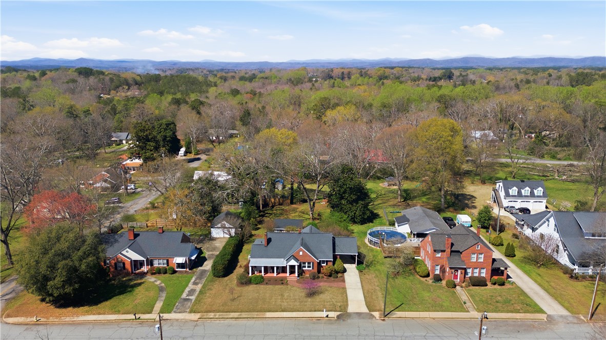 310 Retreat Street Westminster, SC 29693 - Photo 39 of 46 An aerial view captures the neighborhood with scenic mountains and lush greenery.