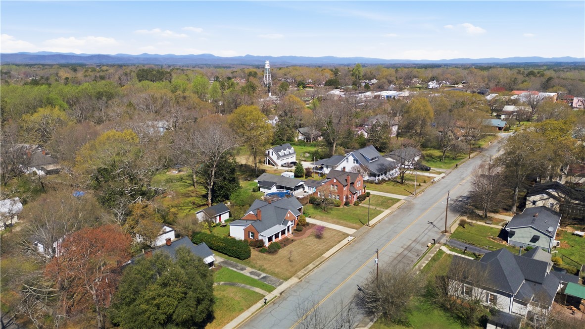 310 Retreat Street Westminster, SC 29693 - Photo 40 of 46 An aerial perspective reveals a tranquil neighborhood nestled amidst verdant landscapes and distant mountains.
