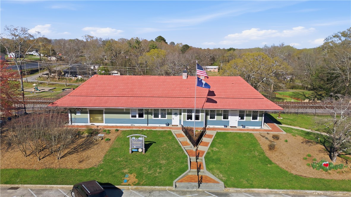 310 Retreat Street Westminster, SC 29693 - Photo 44 of 46 This charming structure features a distinctive red roof and a beautifully landscaped exterior.