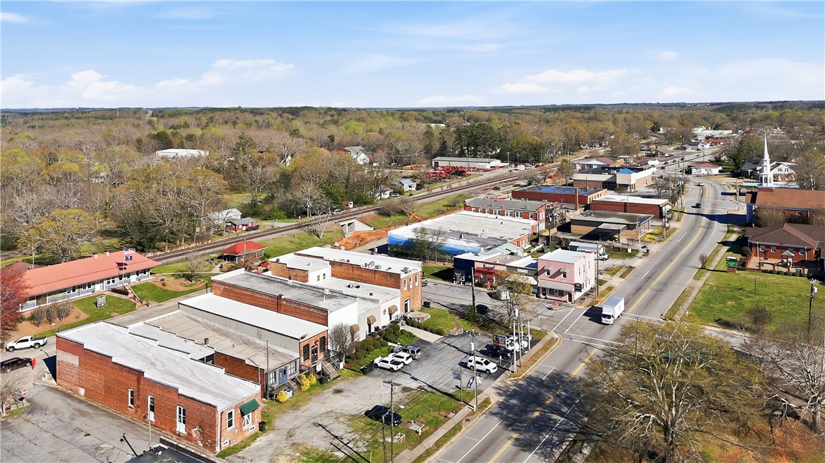 310 Retreat Street Westminster, SC 29693 - Photo 45 of 46 An aerial view captures the vibrant essence of this bustling community, surrounded by lush, mature trees.