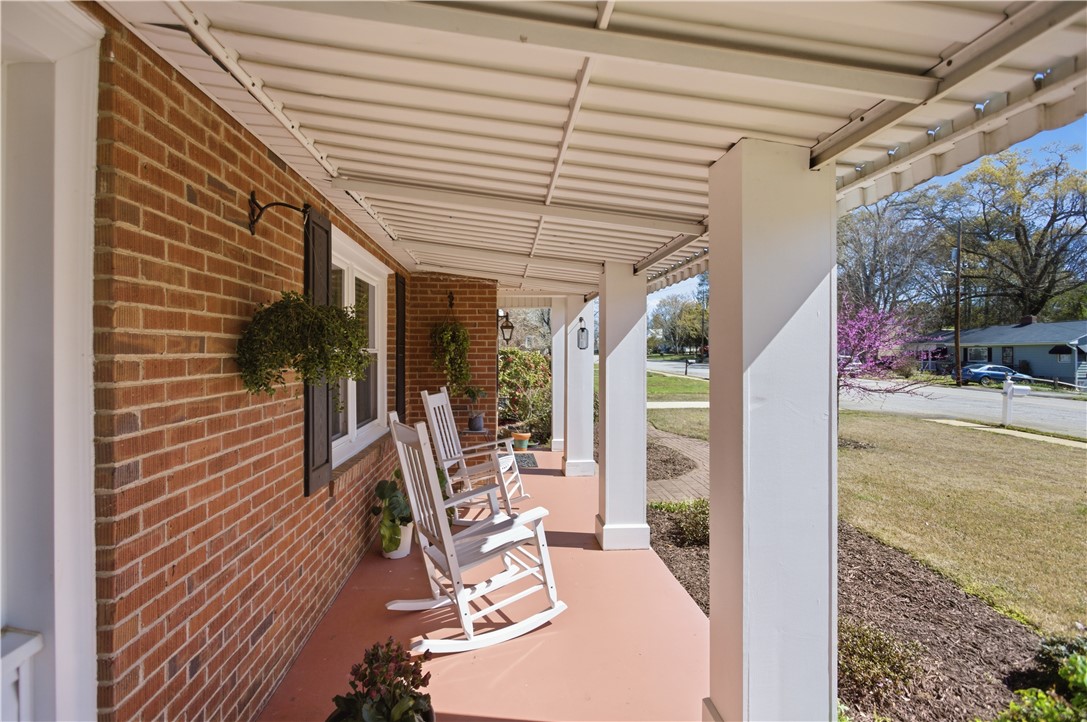 310 Retreat Street Westminster, SC 29693 - Photo 7 of 46 Relax on this inviting covered porch, offering a tranquil outdoor living space with charming details.