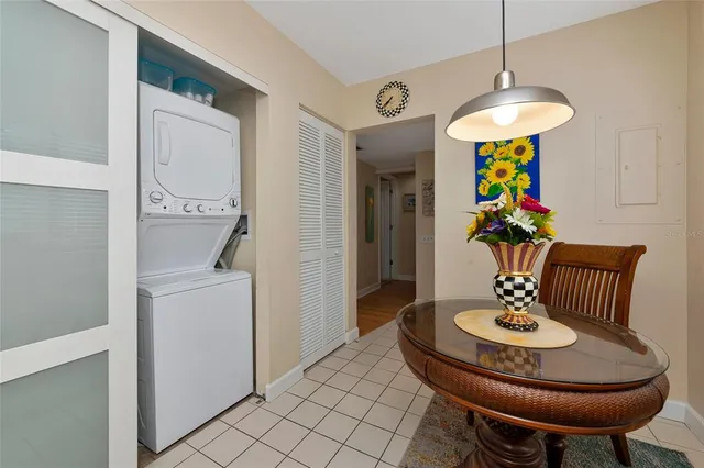 a kitchen with stainless steel appliances kitchen island granite countertop a table and chairs in it