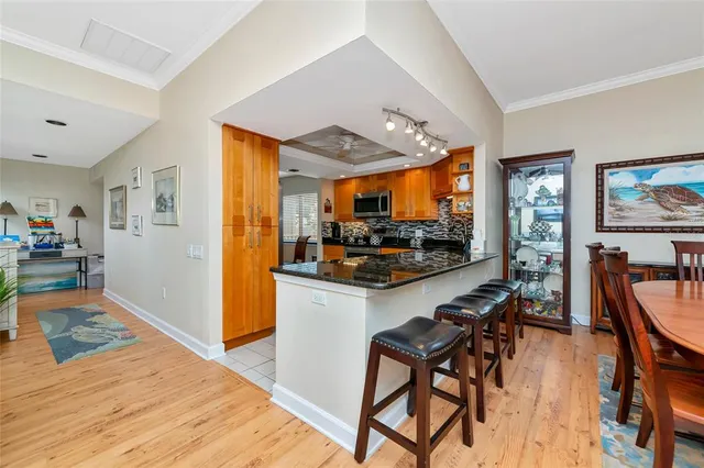 a dining room with furniture a chandelier and wooden floor
