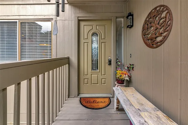 a view of a hallway with entryway wooden floor and front door