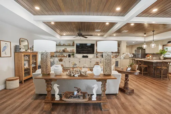 a living room with lots of furniture and kitchen view