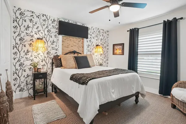 a bedroom with a bed and a chandelier