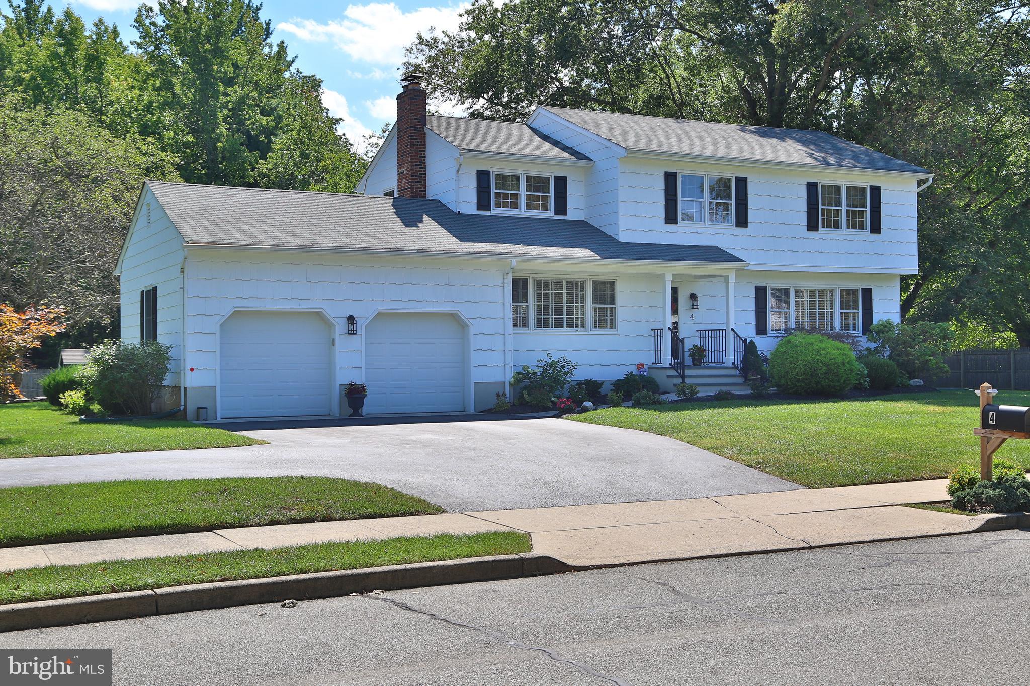 4 Indian Run Road Princeton Junction, NJ 08550 - Photo 1 of 43 a front view of a house with a yard and garage
