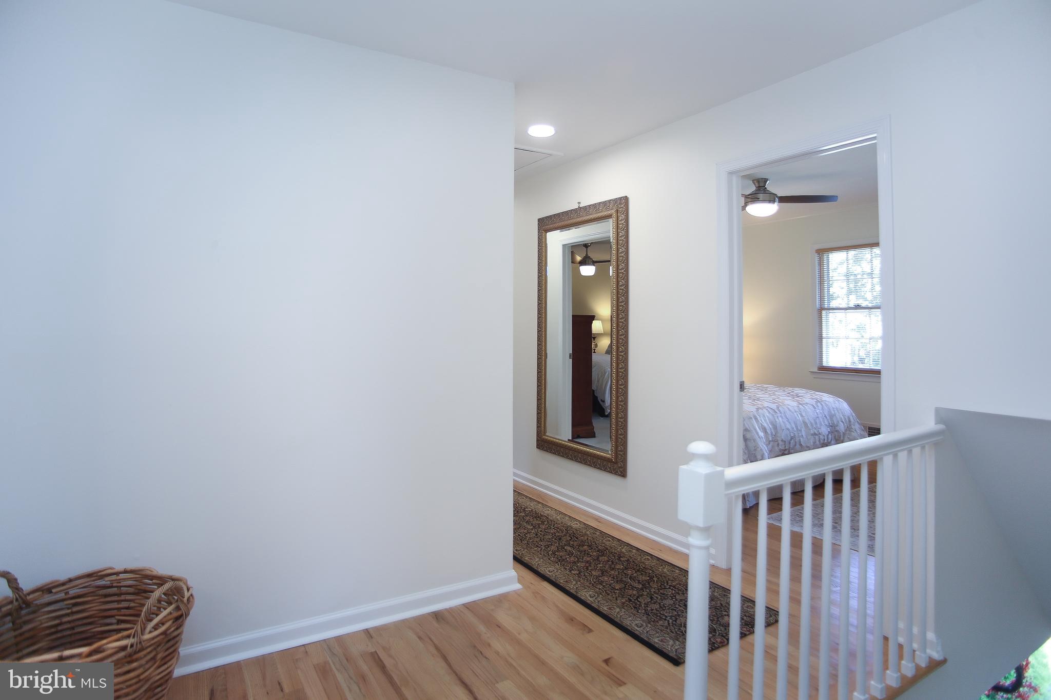 4 Indian Run Road Princeton Junction, NJ 08550 - Photo 31 of 43 a view of a hallway with wooden floor and staircase