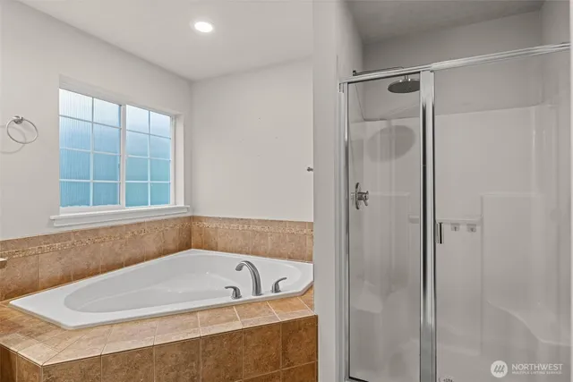 a bathroom with a tub and shower