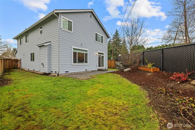 a backyard of a house with garden and garage