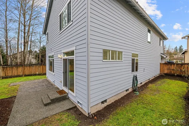 a view of a backyard with a large tree