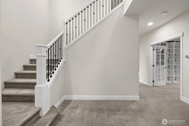 a view of staircase with white walls and windows