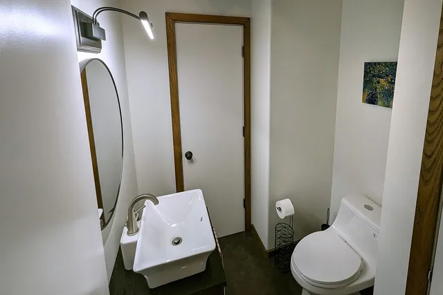 a balcony with wooden floor and white walls