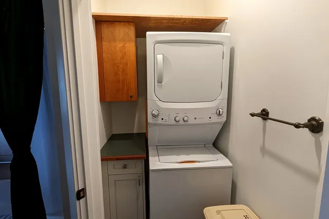 a view of a balcony with chairs and wooden floor