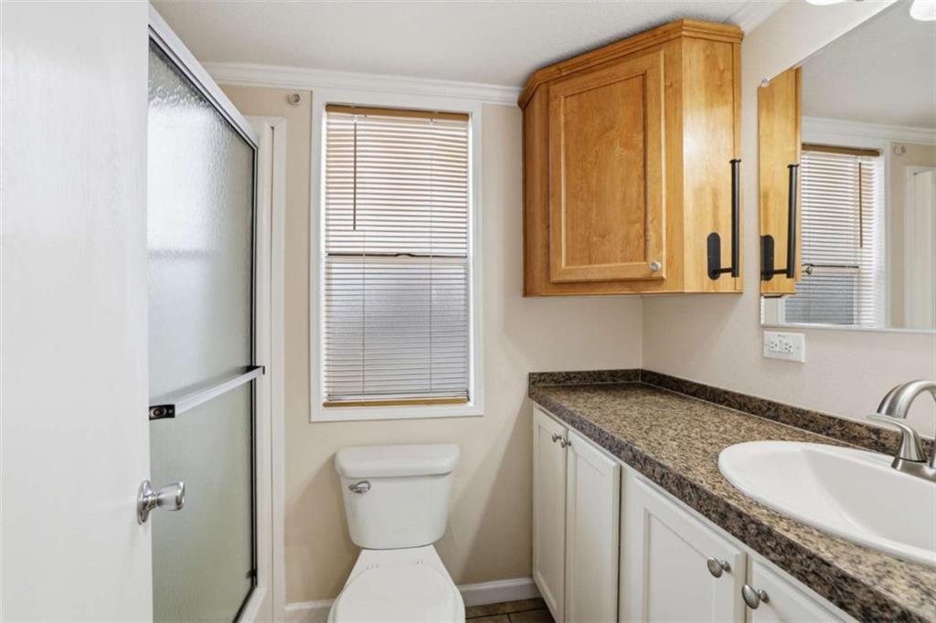 96 Stag Leap Drive Cleveland, GA 30528 - Photo 11 of 42 a bathroom with a granite countertop sink toilet and mirror