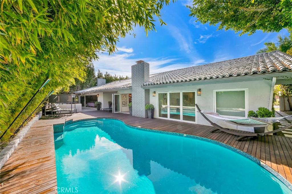13692 Jenet Circle Santa Ana, CA 92705 - Photo 19 of 68 a front view of a house with swimming pool table and chairs