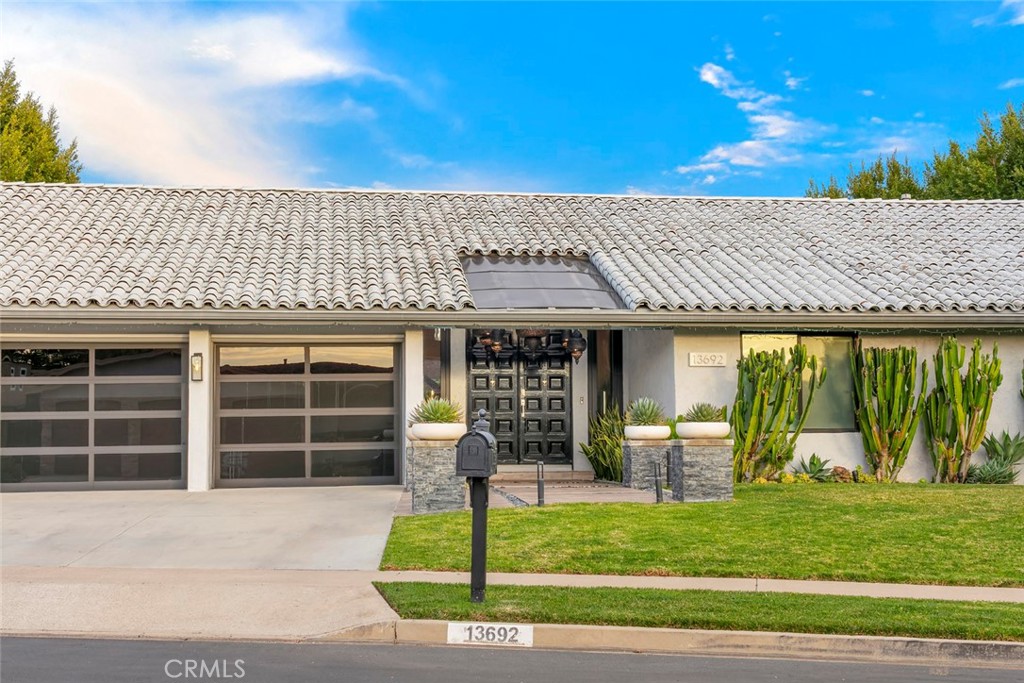 13692 Jenet Circle Santa Ana, CA 92705 - Photo 65 of 68 a front view of a house with a garden and plants