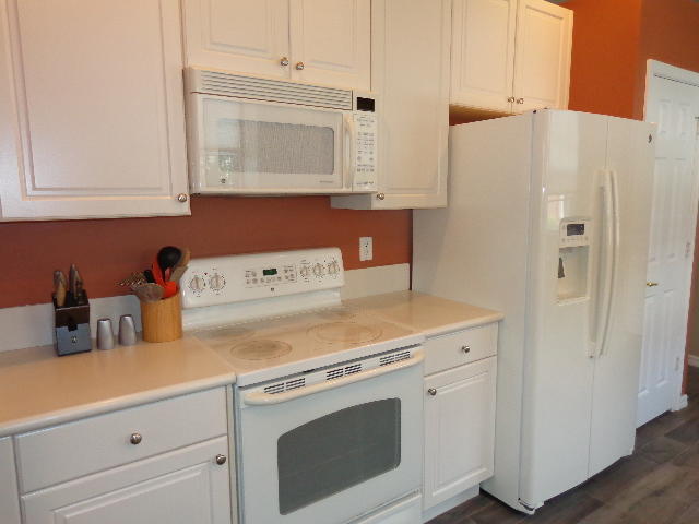 33 Lancaster Road Boynton Beach, FL 33426 - Photo 8 of 34 a utility room with stainless steel appliances white cabinets and a refrigerator