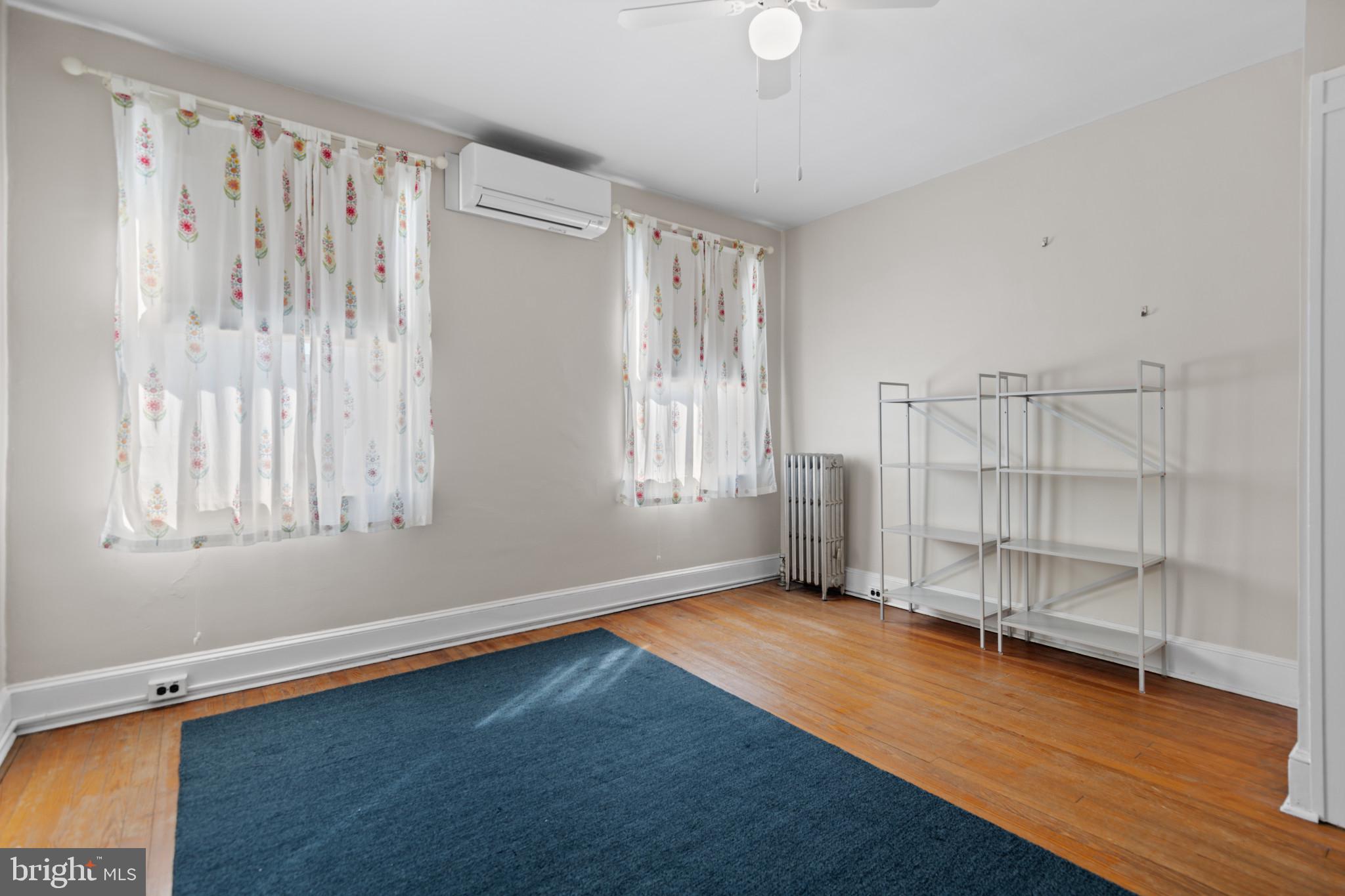 1228 West 37th Street Baltimore, MD 21211 - Photo 12 of 23 a view of an empty room with wooden floor and a window
