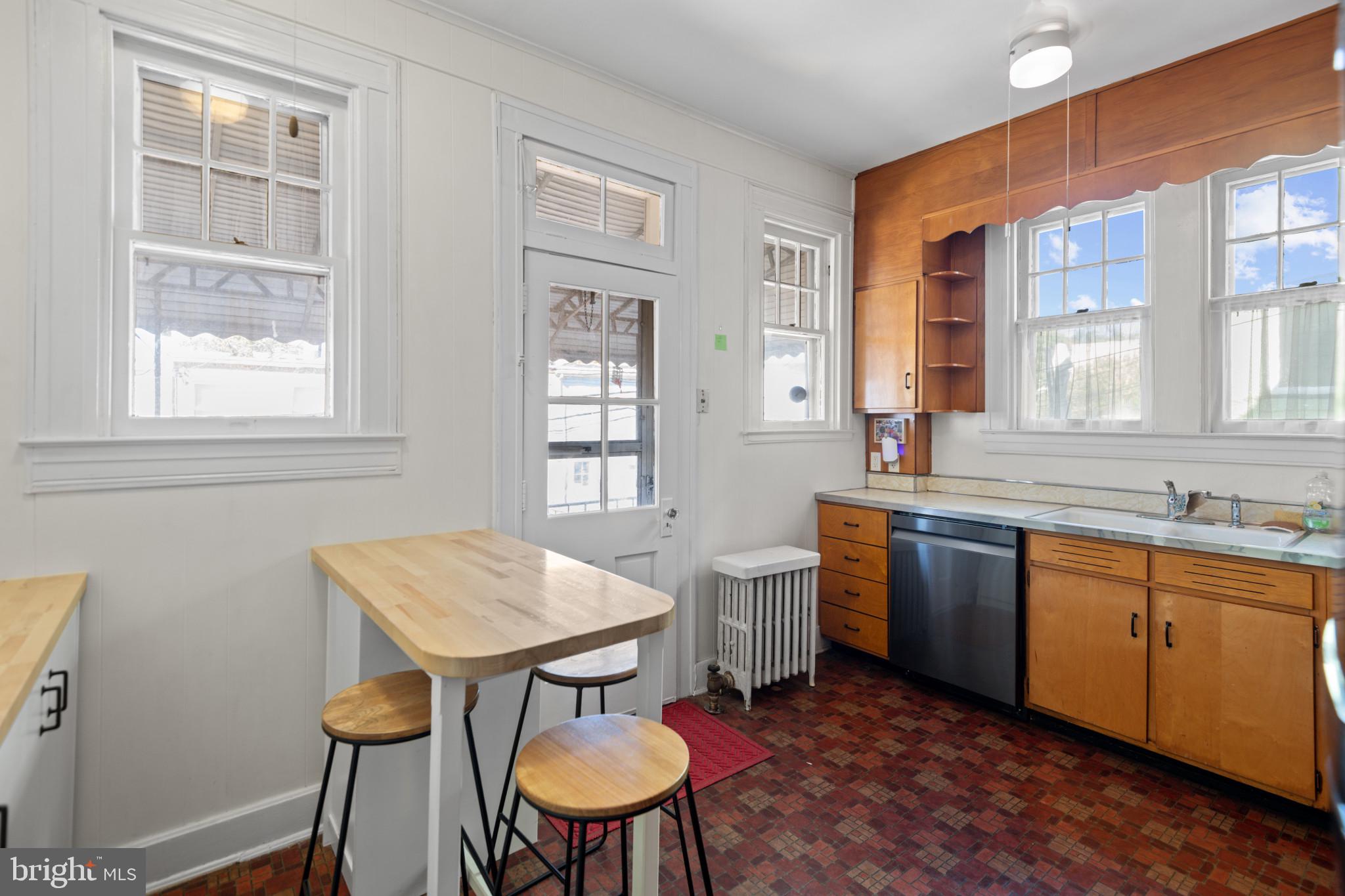 1228 West 37th Street Baltimore, MD 21211 - Photo 9 of 23 a view of a kitchen area with furniture and wooden floor
