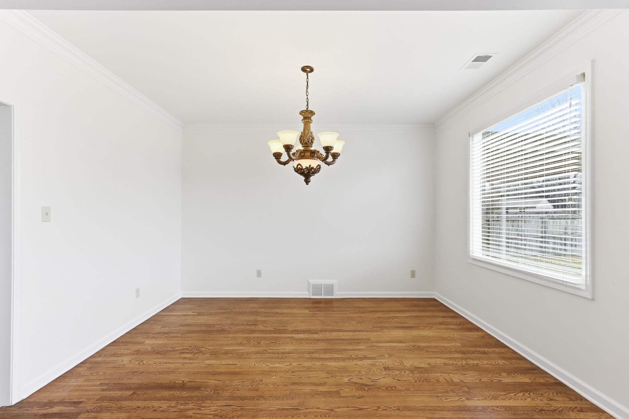 4854 Fox Springs Drive Collierville, TN 38017 - Photo 23 of 39 Unfurnished dining area featuring a chandelier, crown molding, and wood finished floors