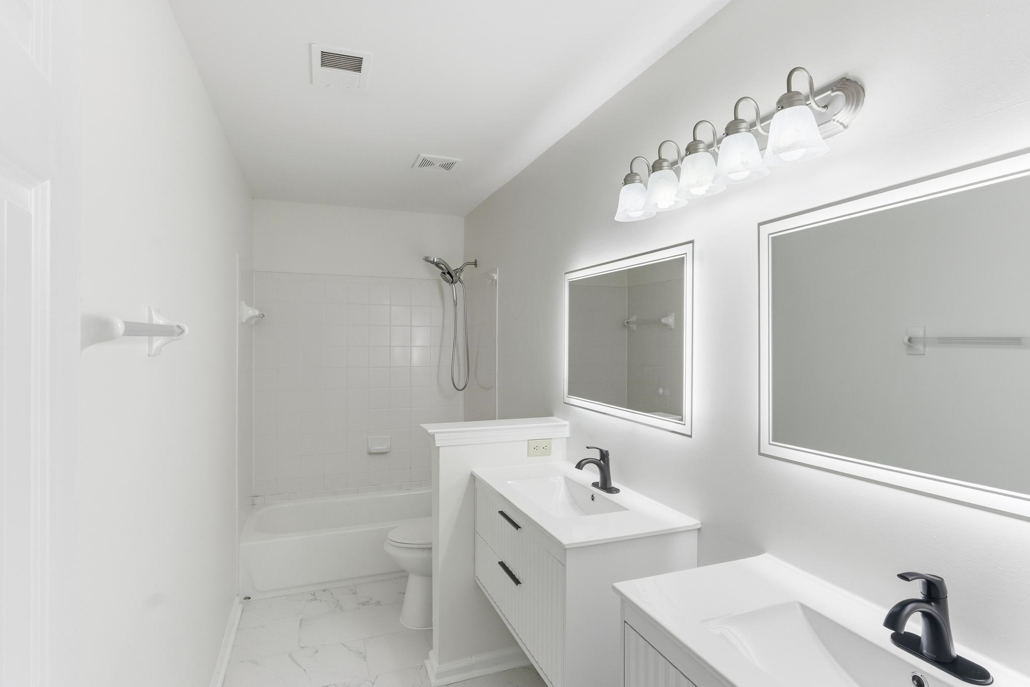 4854 Fox Springs Drive Collierville, TN 38017 - Photo 31 of 39 Full bath featuring two vanities, shower / bath combination, and light marble finish flooring