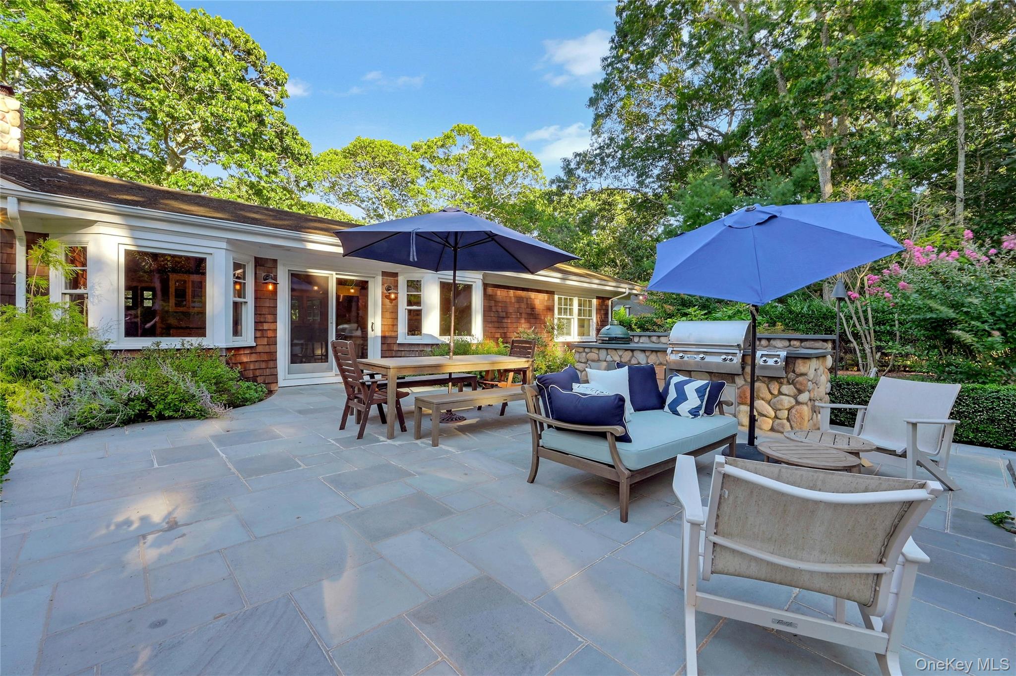1600 Pine Tree Road Cutchogue, NY 11935 - Photo 19 of 27 a view of patio with chairs and table under an umbrella with a barbeque