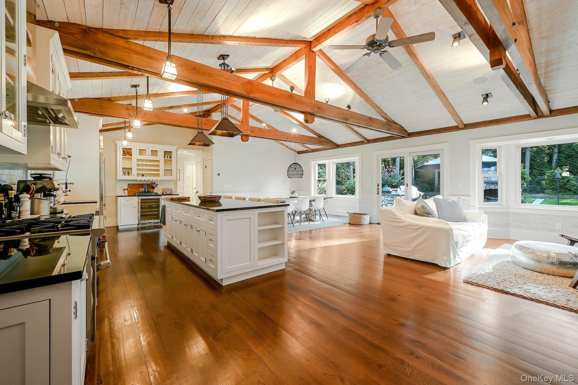1600 Pine Tree Road Cutchogue, NY 11935 - Photo 2 of 27 a view of a living room and kitchen with wooden floors
