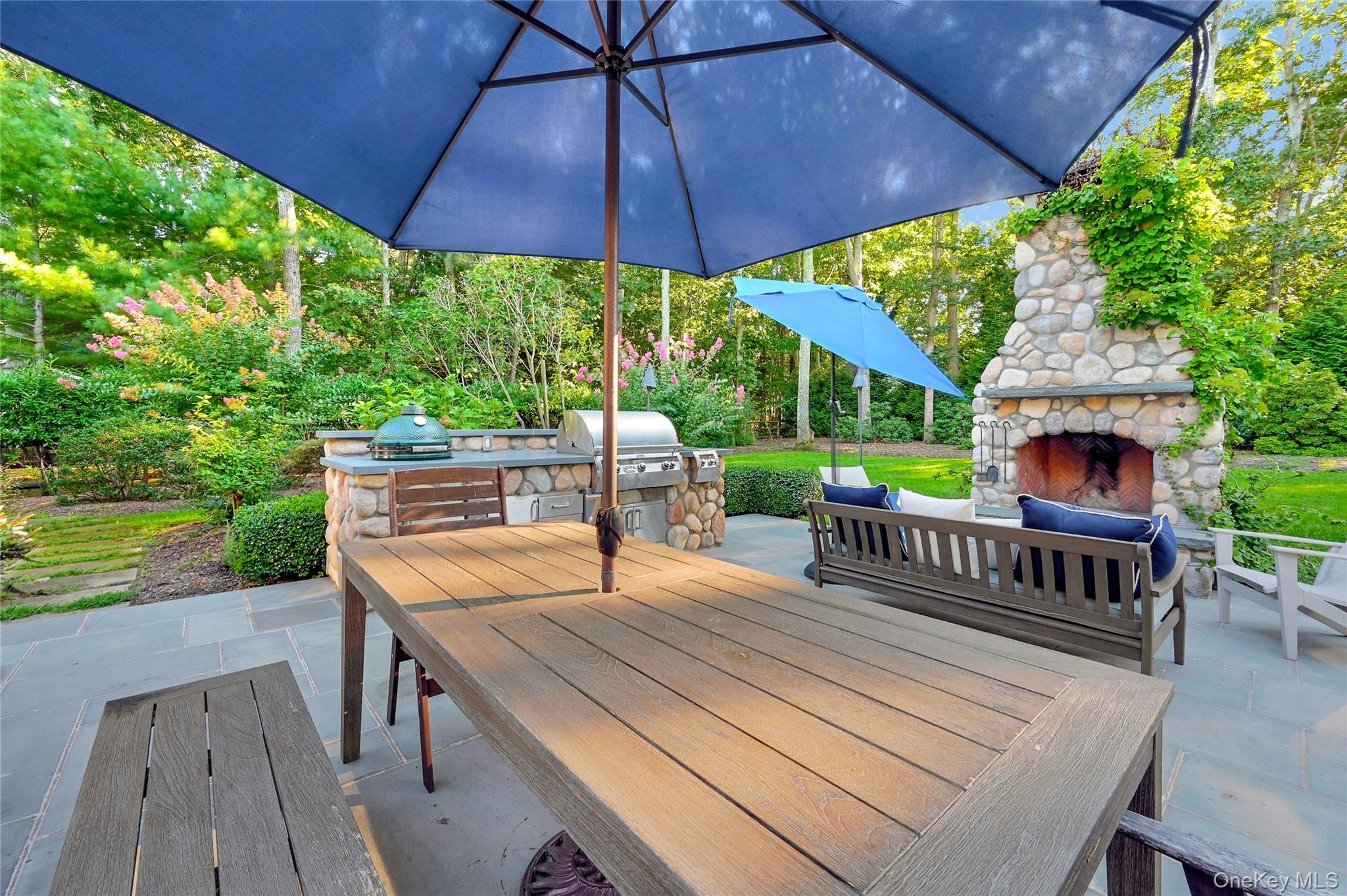 1600 Pine Tree Road Cutchogue, NY 11935 - Photo 21 of 27 a view of a patio with a table chairs and a umbrella